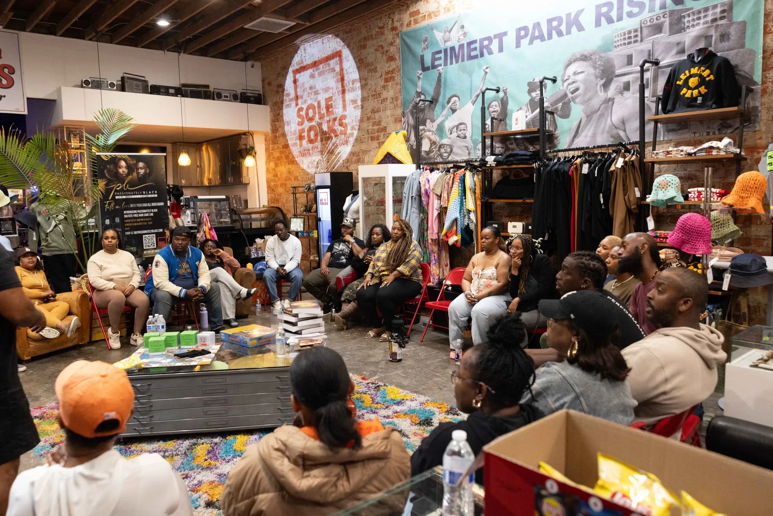 Community members seated in a weekly healing circle at Sole Folks in Leimert Park, Los Angeles, hosted by The Healing Circle LA